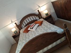 a bedroom with a wooden bed with two night stands at Casita de Florida 2 in Florida