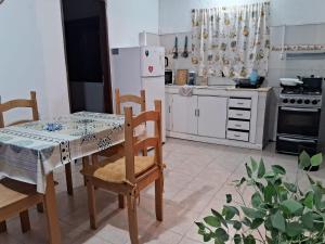 a kitchen with a table and chairs and a refrigerator at Casita de Florida 2 in Florida