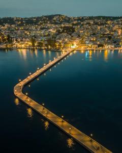 a bridge over a large body of water at night at Acqui Apartments in Argostoli