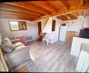 a living room with a couch and a kitchen at Chalet à la campagne 40m2 in Charleval