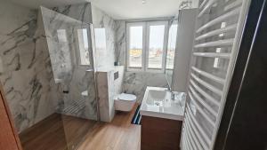 a bathroom with a shower and a sink and a toilet at Willa 2 piętro in Szczecinek +19 photos