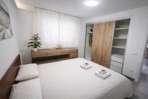a bedroom with a bed with two towels on it at VIP private Poolsuite Calafell in Calafell +5 photos