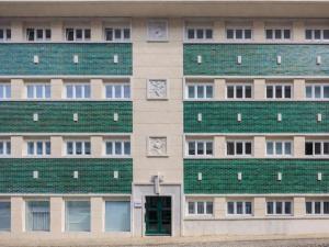 a building with a green roof and a door at LSA Príncipe Real by Numa in Lisbon