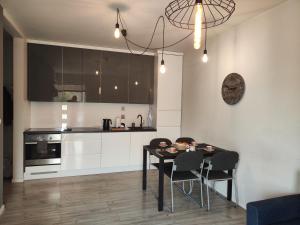 a kitchen with a table and chairs in a room at Apartament Ela in Żywiec