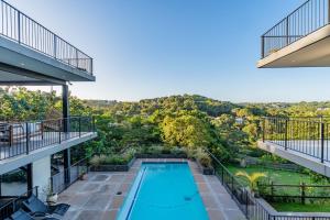 an apartment with a swimming pool and balconies at Tuna Room in Ballito +23 photos