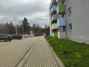 a parking lot next to a building with cars parked at Apartament Ela in Żywiec