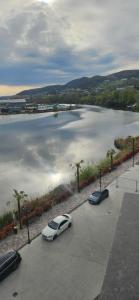 a car parked in a parking lot next to a body of water at New studio in Râmnicu Vâlcea