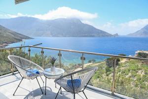 a balcony with chairs and a view of the ocean at Platanos Apartments in Kalymnos