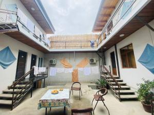 a room with stairs and a table and chairs at Guest house Afsona old city in Bukhara