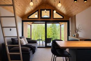 a living room with a couch and a table at Dushka Mountain Cabin in Belec