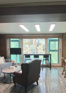 a living room with a couch and a table at 부산남포 프론트오션뷰 in Busan