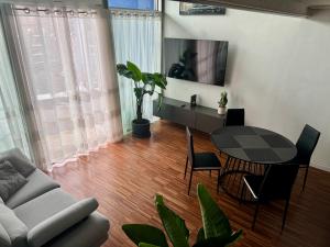 a living room with a table and a couch at Private Luxury Loft in Crescenzago