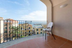 a balcony with a chair and a view of a building at San Francesco Amalfi Coast Hotel in Maiori +33 photos