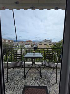 a patio with a table and chairs on a balcony at Cosy apartment in Sparta in Sparta
