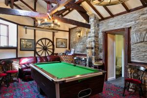 a living room with a pool table in it at Finest Retreats - Trimstone Manor, Manor Cottage in Woolacombe