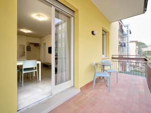 a balcony with chairs and a table on a balcony at Pegaso Civico2 in Garda