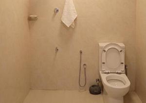 a bathroom with a toilet and a shower at Eco Bliss Ragama in Ragama