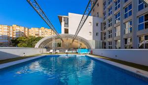 a swimming pool in the middle of a building at Vértice Sevilla in Seville