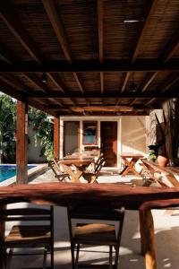 a patio with chairs and a table and a pool at POUSADA RANCHO PARAISO in Pôrto de Pedras