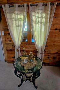 a glass table with two glasses on it in front of a window at Domaine d'Avalon in Lorgues