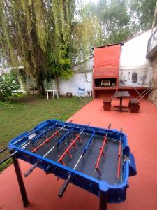 a blue trampoline on a red floor in a yard at Depto Brochero in Mina Clavero