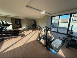 a gym with exercise equipment and a large window at Alugo QUARTO em Apartamento -Centro de Recife in Recife
