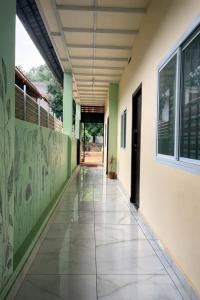 an empty hallway of a school with green and white walls at WAYNEST by SHELTERS in Meppādi