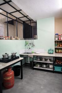 a kitchen with pots and pans on the counters at WAYNEST by SHELTERS in Meppādi