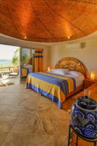 a bedroom with a bed with a wooden ceiling at Ventana Bay Resort in La Ventana