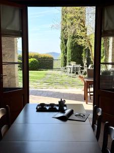 a table in a room with a view of a patio at CasAle 1896 in Cavaso del Tomba
