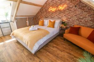 a bedroom with a bed and a brick wall at Seagulls Nest in St Ives