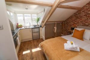 a bedroom with a bed with white towels on it at Seagulls Nest in St Ives