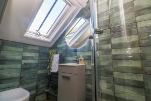 a bathroom with a toilet and a sink and a window at Seagulls Nest in St Ives +18 photos