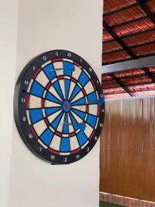 a dart board hanging on a wall at Riveria By Vstays in Kozhikode +14 photos