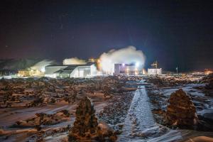 a factory at night with snow and smoke at Northern Light Inn in Grindavík