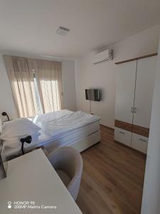 a bedroom with a bed and a dresser in it at Adriatica in Zadar