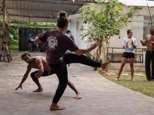 a group of people in a yoga class with one person on the ground at Pipa Roots Hostel in Pipa