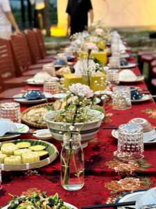 a long table with plates of food on it at Dhami Farmstay, Đông Giang, Đà Nẵng in Danang