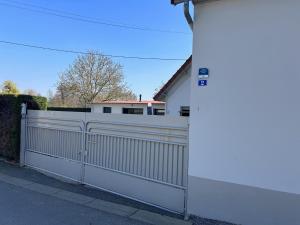 a white fence in front of a house at le relais des étangs B in Mareuil-Caubert +28 photos