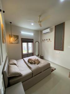a bedroom with a large bed in a room at Riveria By Vstays in Kozhikode