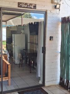 a glass door to a patio with a table in it at Lullaby Leaf in Lichtenburg