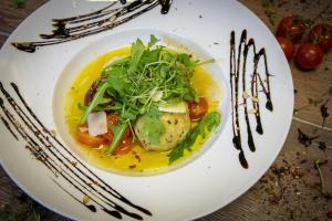 a white plate with a plate of food on a table at Hotel-Restaurant Früchtl in Zandt