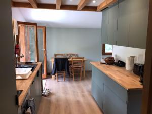 a kitchen with a counter and a table in it at Calm Waters in Doussard