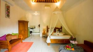 a bedroom with a bed and a couch at The Oding House in Ubud +16 photos