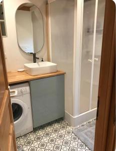 a bathroom with a sink and a washing machine at Calm Waters in Doussard +10 photos