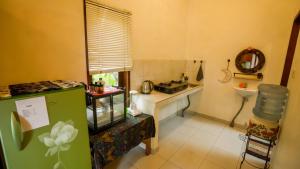 a small kitchen with a counter and a sink at The Oding House in Ubud