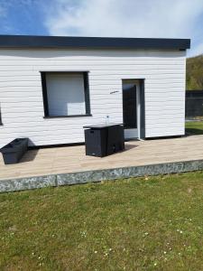 a building with a patio with two tables on it at Studio de Vincent in Bordeaux-Saint-Clair