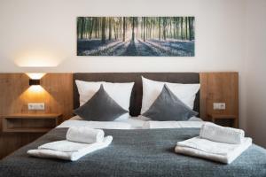 a bedroom with a bed with two towels on it at Das Sill by Inncomer in Innsbruck +47 photos