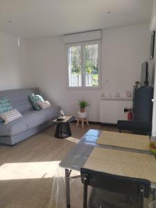a living room with a couch and a table at Studio de Vincent in Bordeaux-Saint-Clair