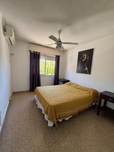 a bedroom with a bed and a ceiling fan at SIERRAS TRAVEL 2f in Villa Carlos Paz